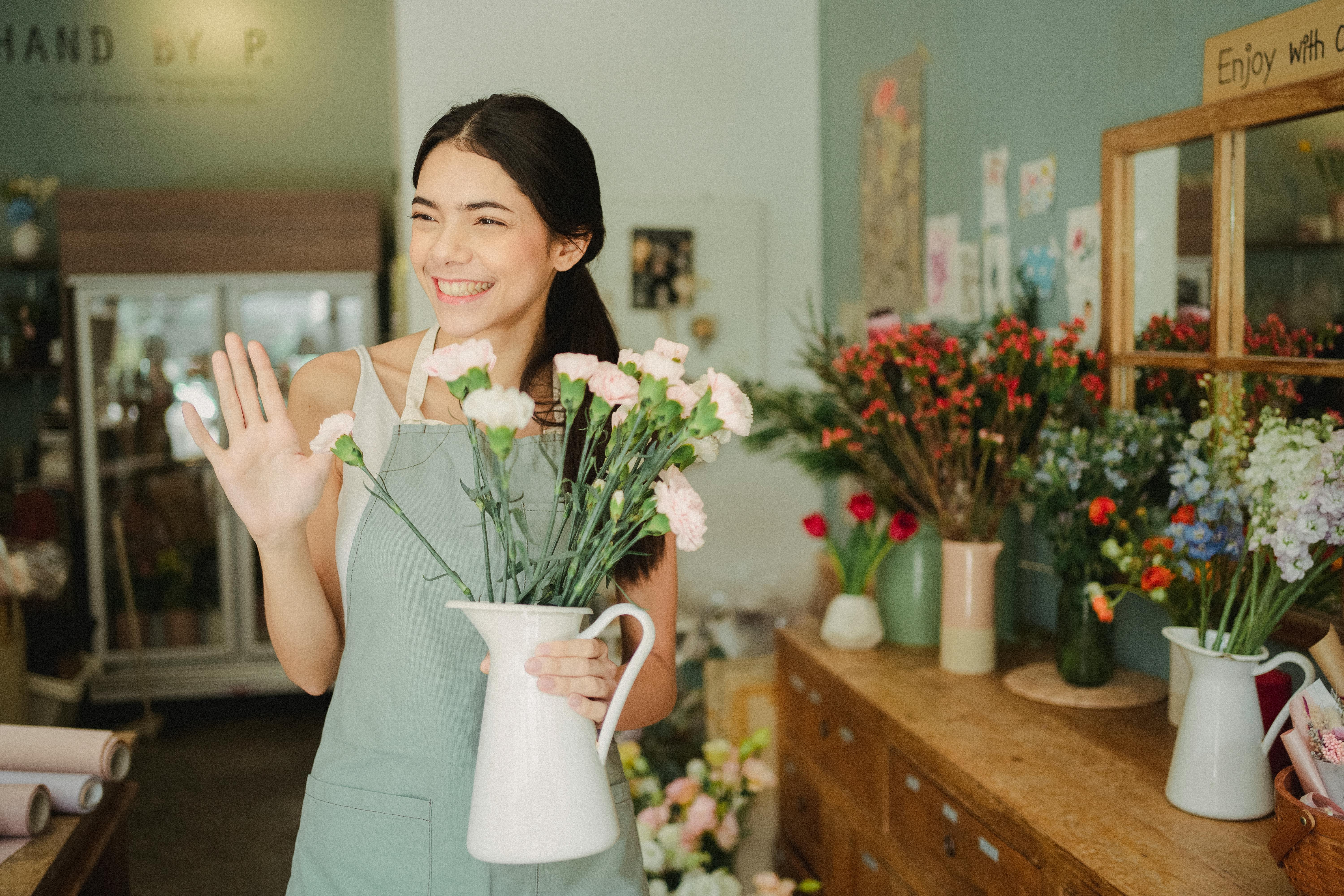 Florist welcoming customers in her flower shop